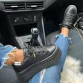 Casual Platform Women's Shoes Flat Womens Sneakers worn with ripped jeans inside a car.